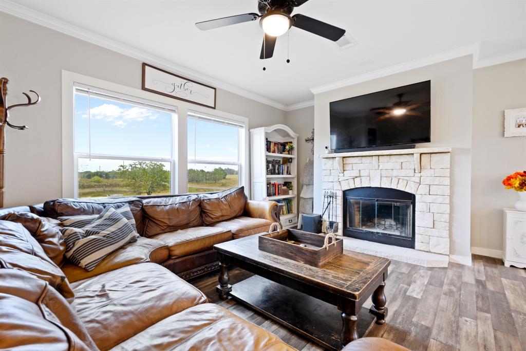 a living room with furniture a flat screen tv and a fireplace