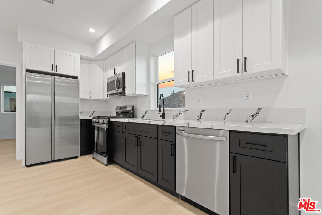 a kitchen with a sink stove and refrigerator