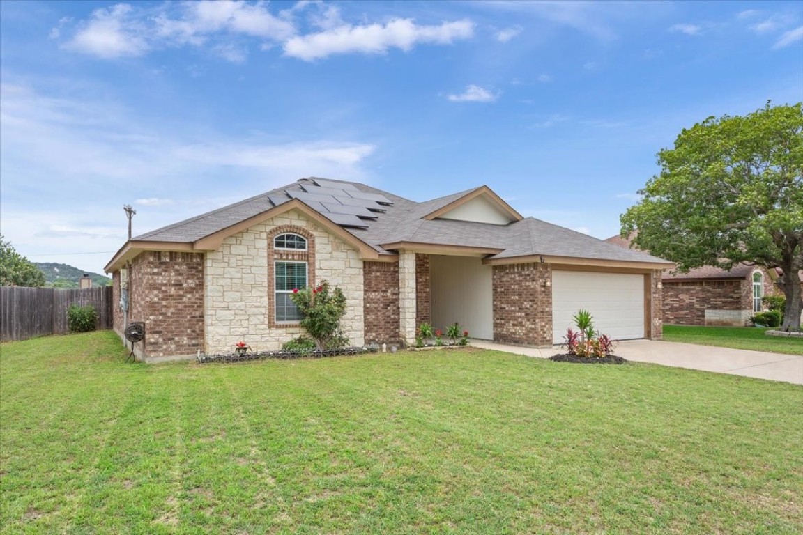 a front view of a house with a yard and garage