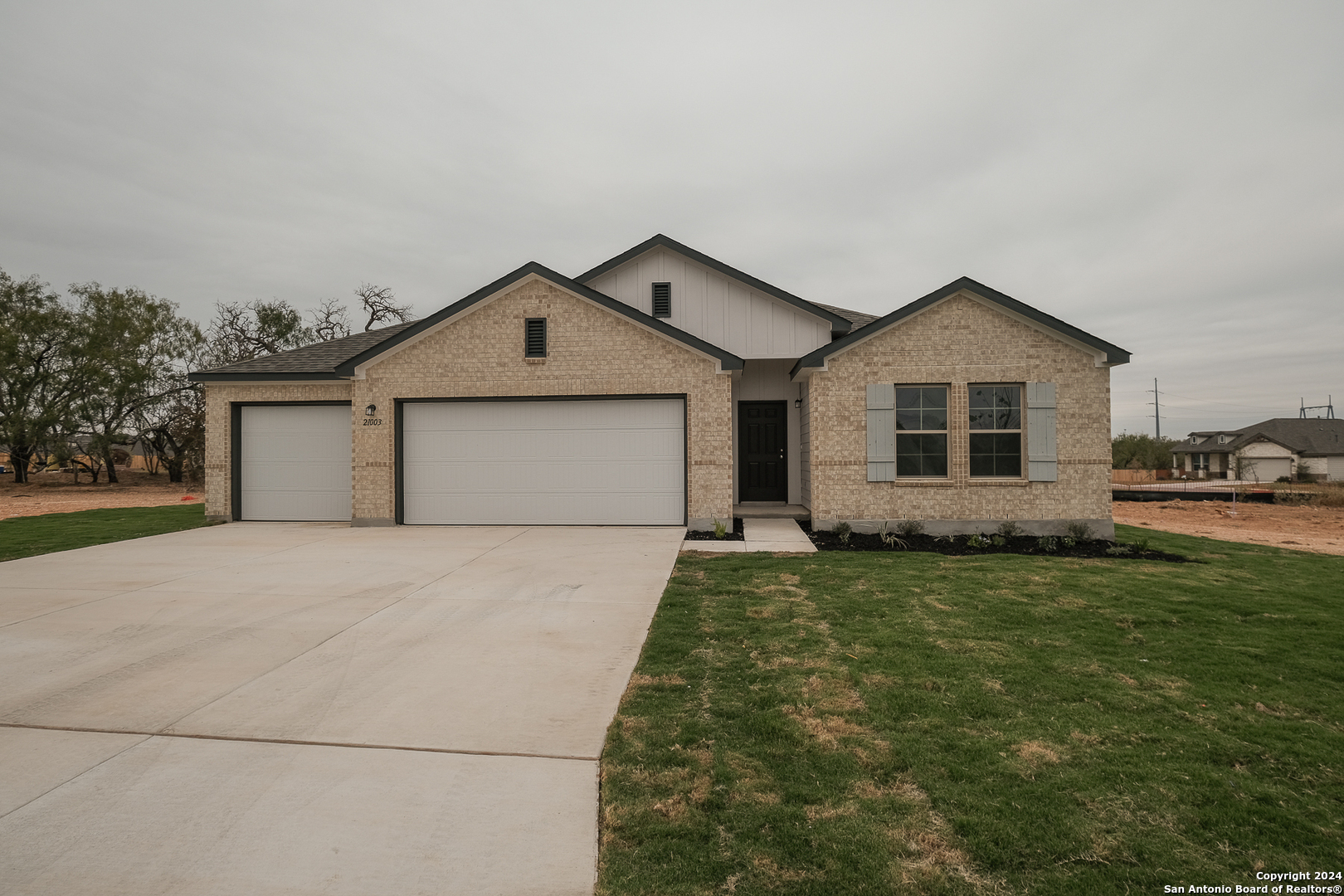 a front view of a house with a yard and garage