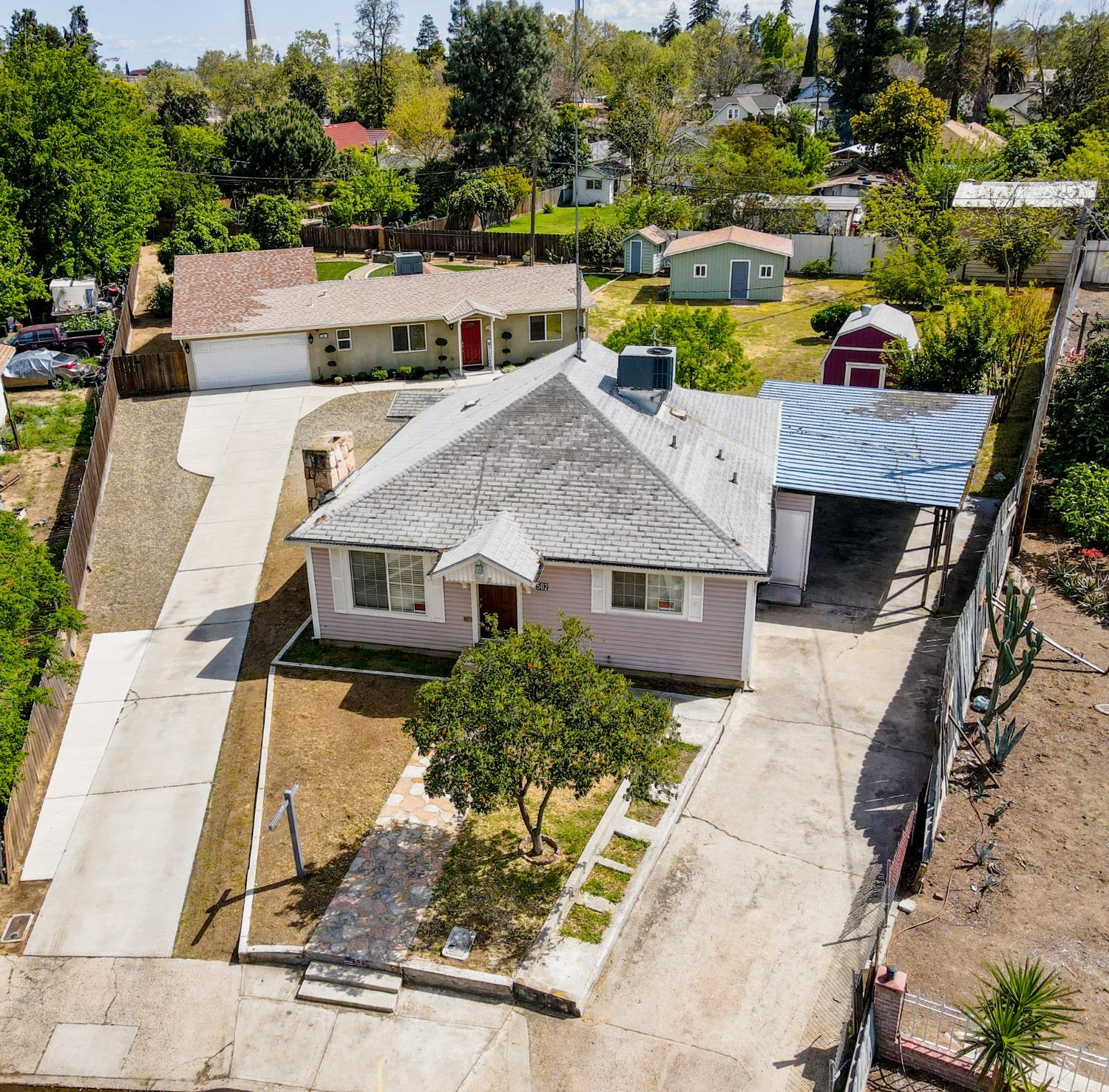 an aerial view of a house with a yard and lake view