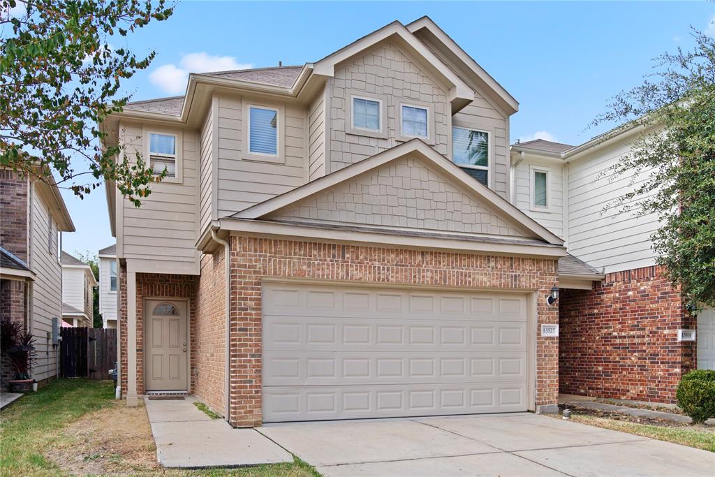 a view of a house with a yard and garage