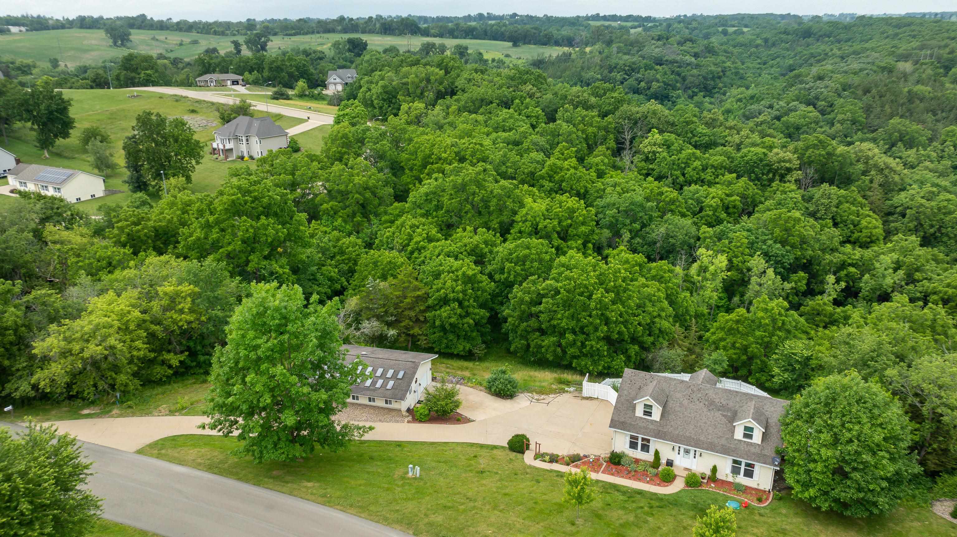 an aerial view of a house with a garden and lake view