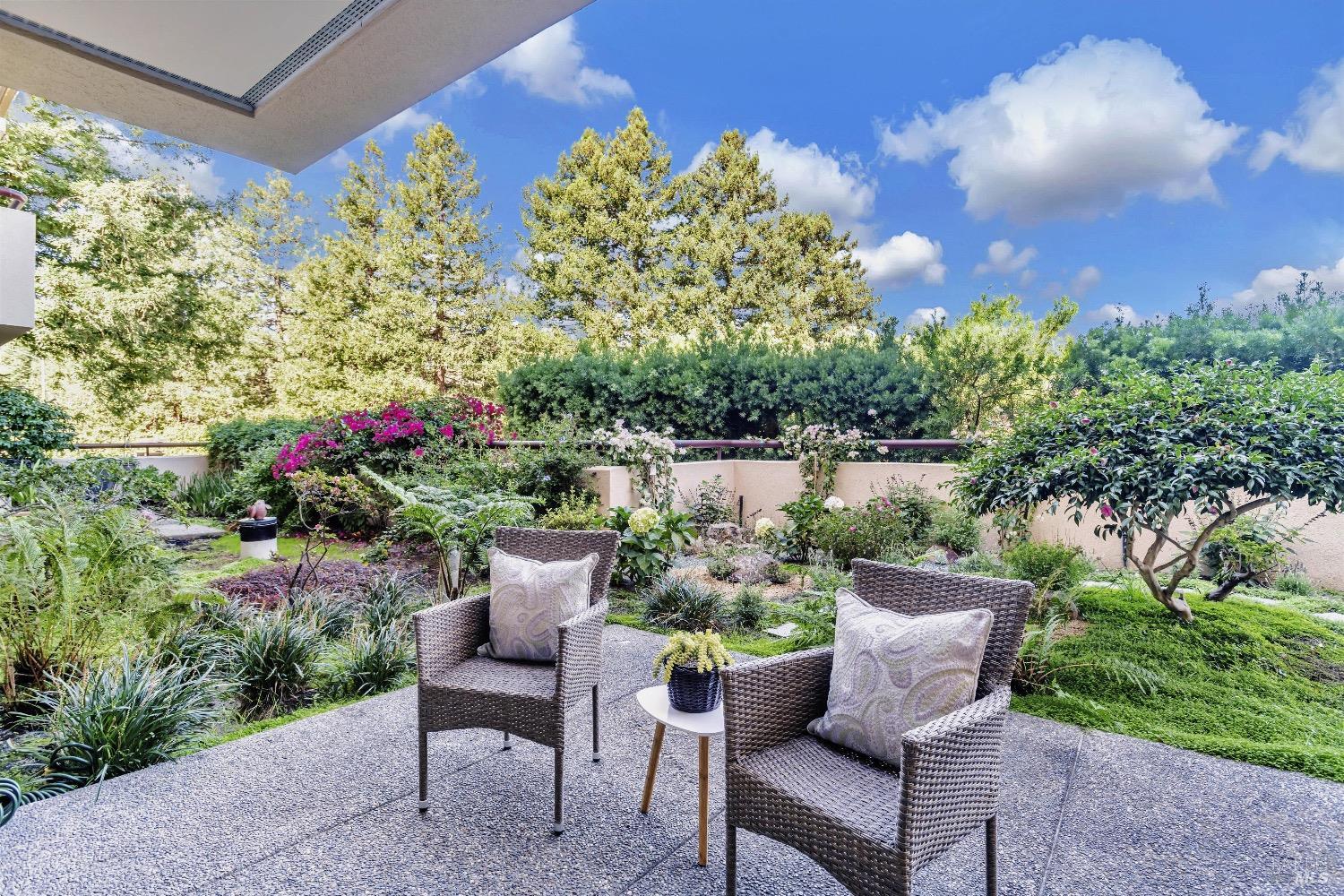 a view of a porch with furniture and a garden