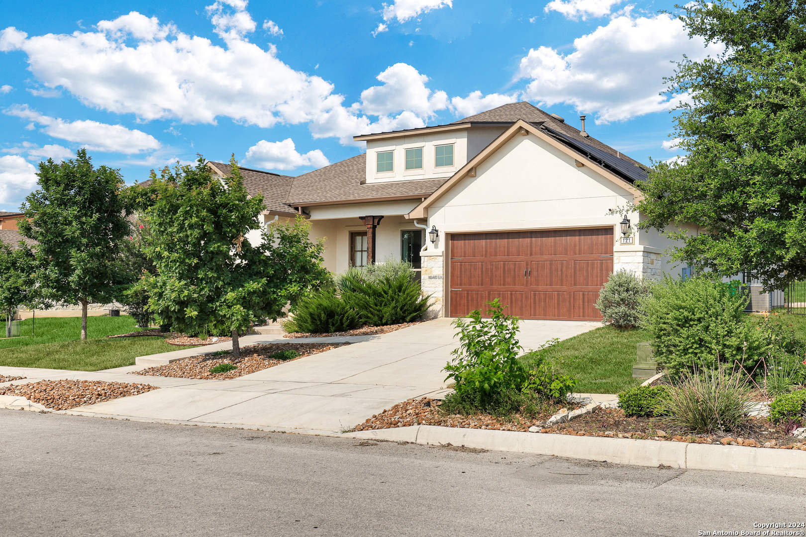 a front view of a house with a yard and a garage