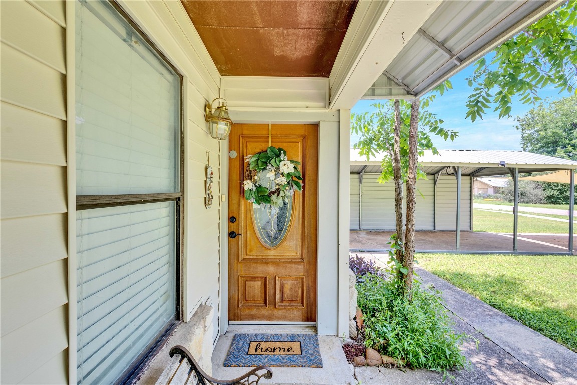 a view of a door and chair in front of a house