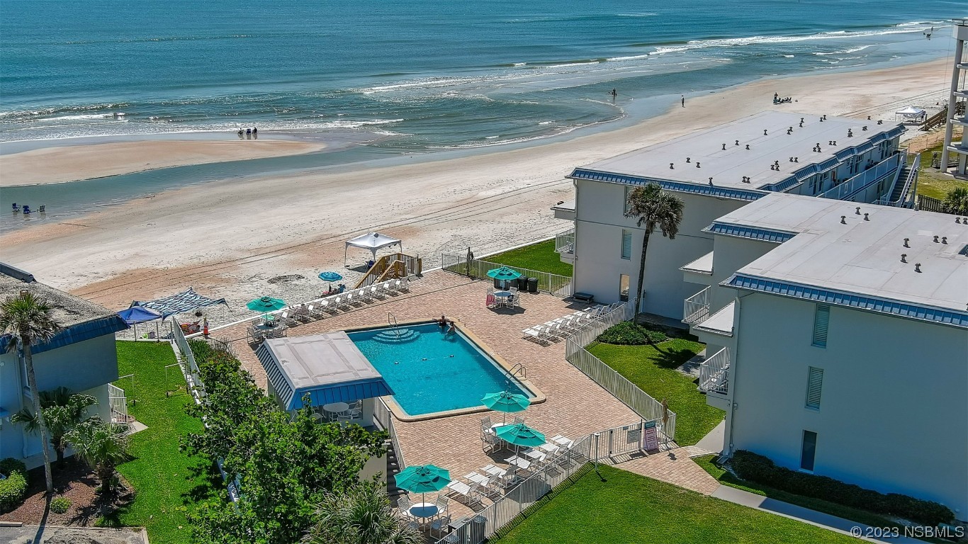 an aerial view of house with yard swimming pool and outdoor seating