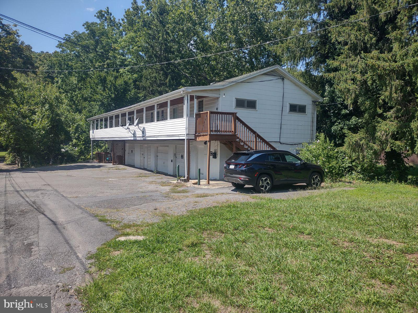 a view of house with backyard and trees