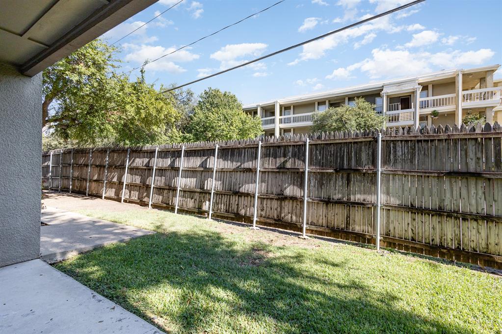 a view of a backyard with wooden fence