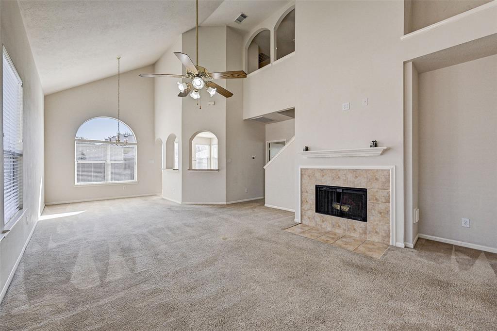 wooden floor fireplace and windows in an empty room