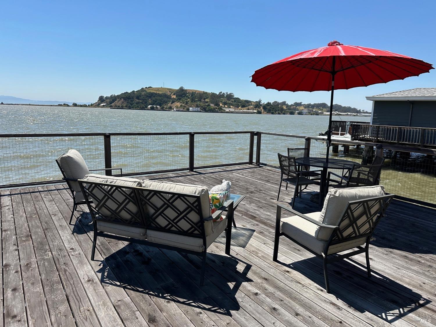 a view of a roof deck with furniture