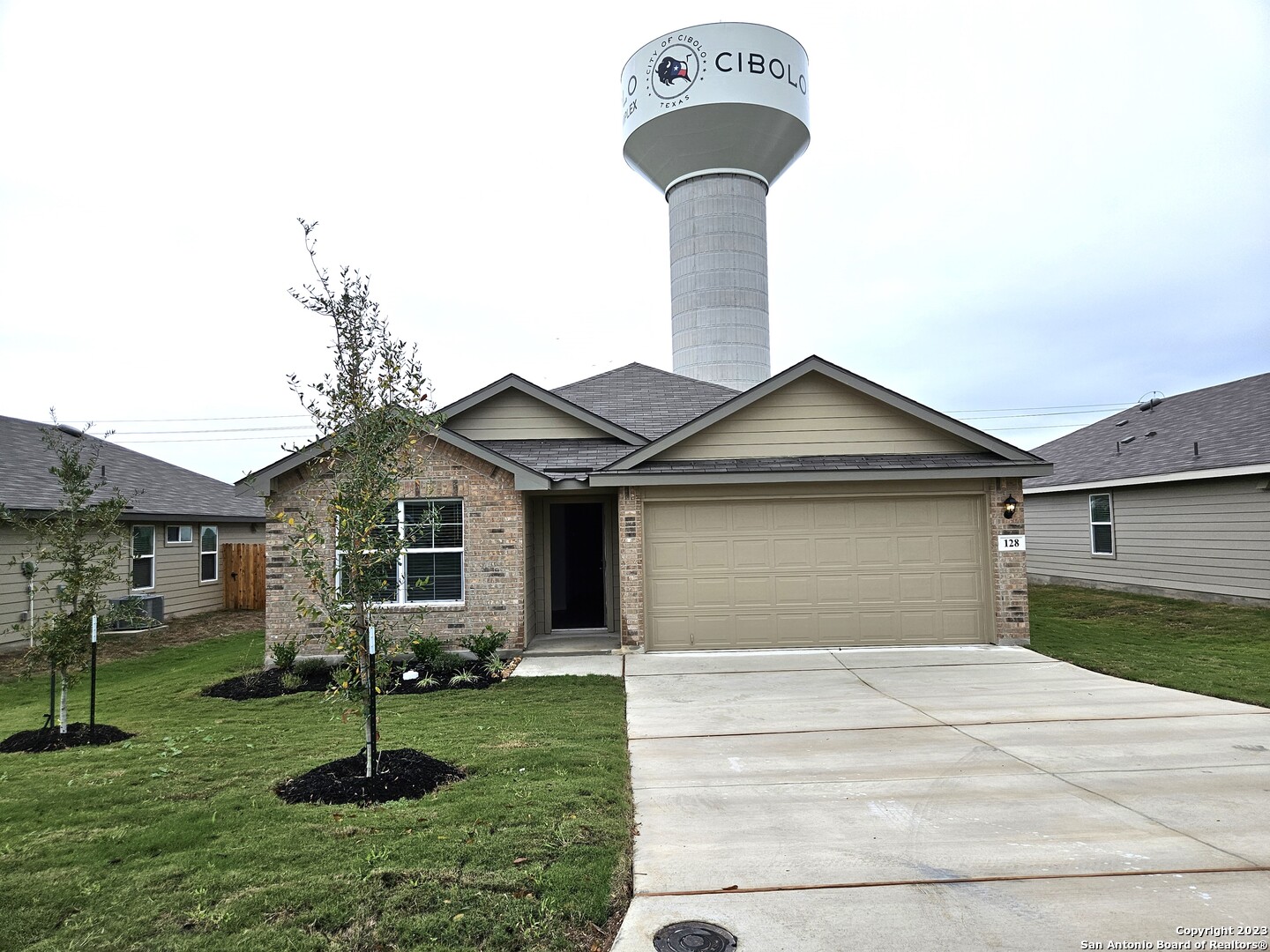 a front view of a house with a garden and yard