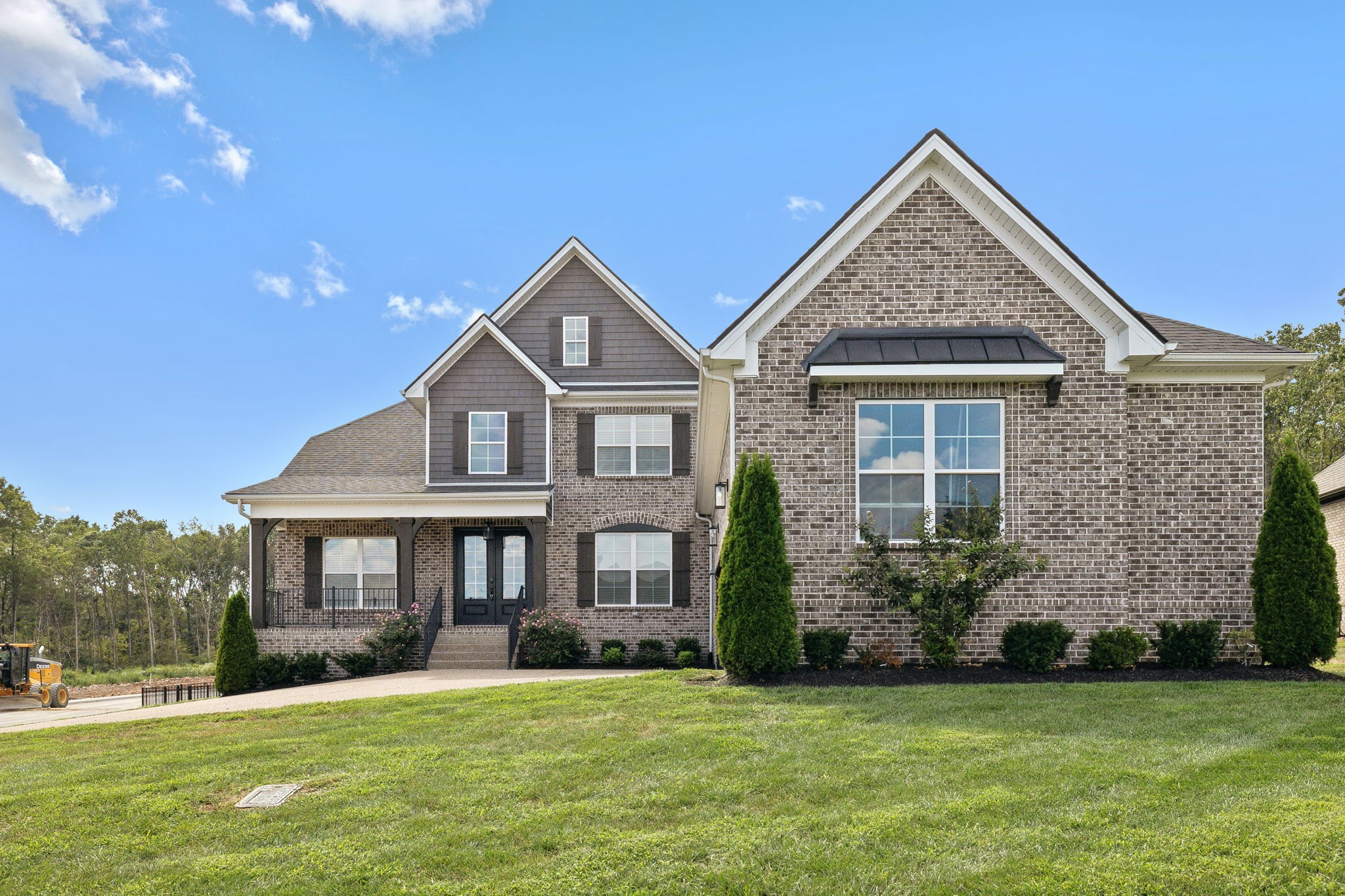 a front view of a house with a yard