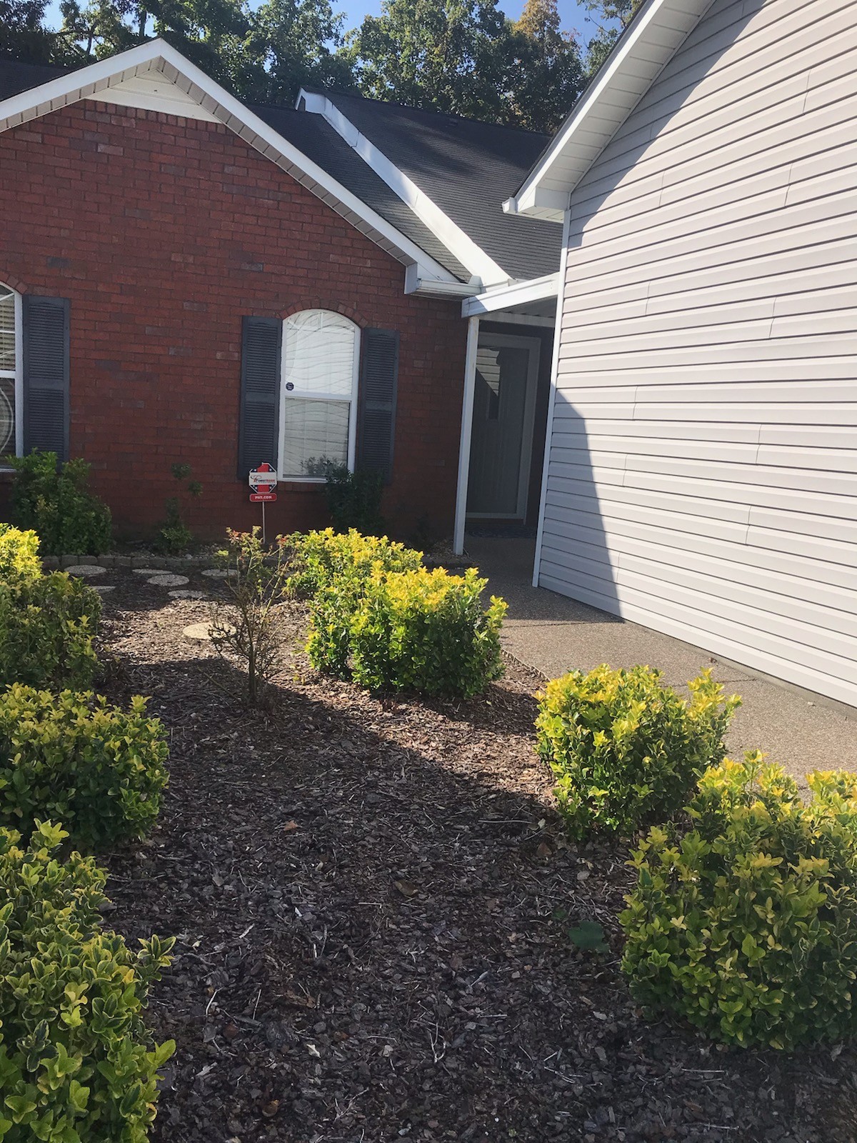 a front view of a house with garden