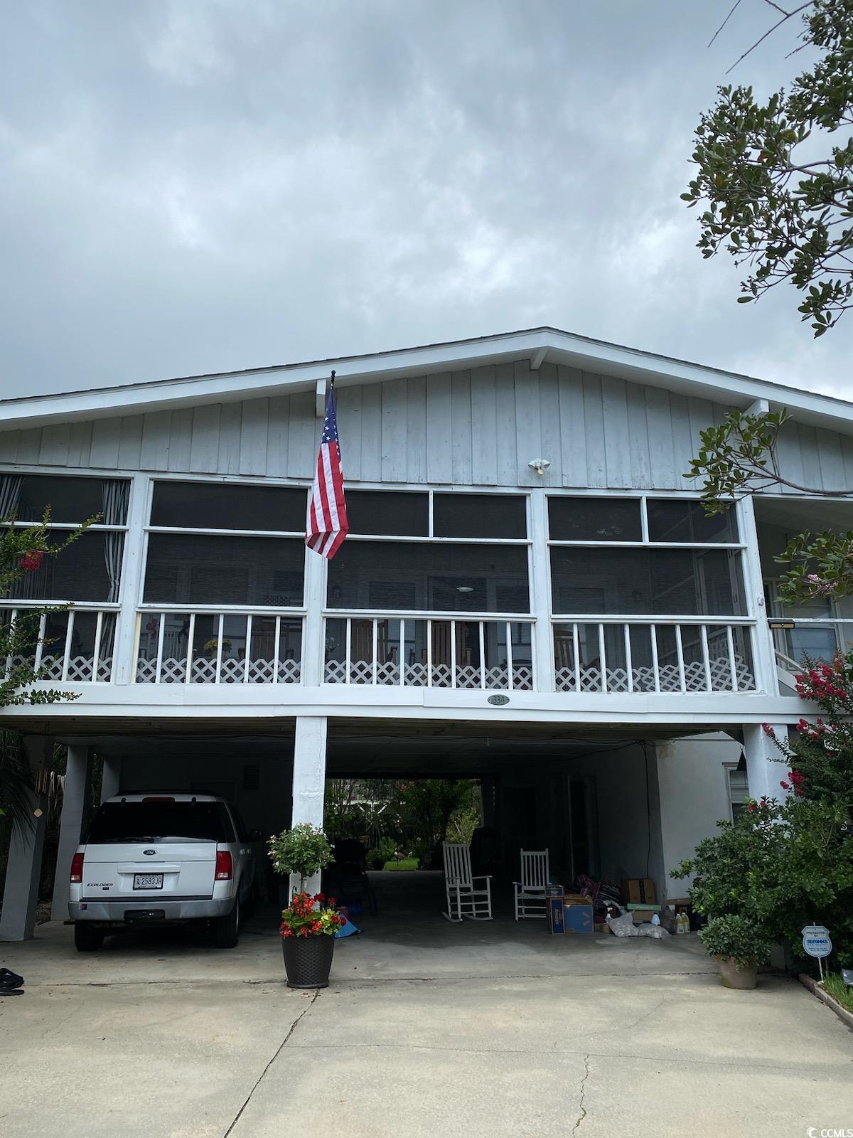 View of front of property featuring a carport