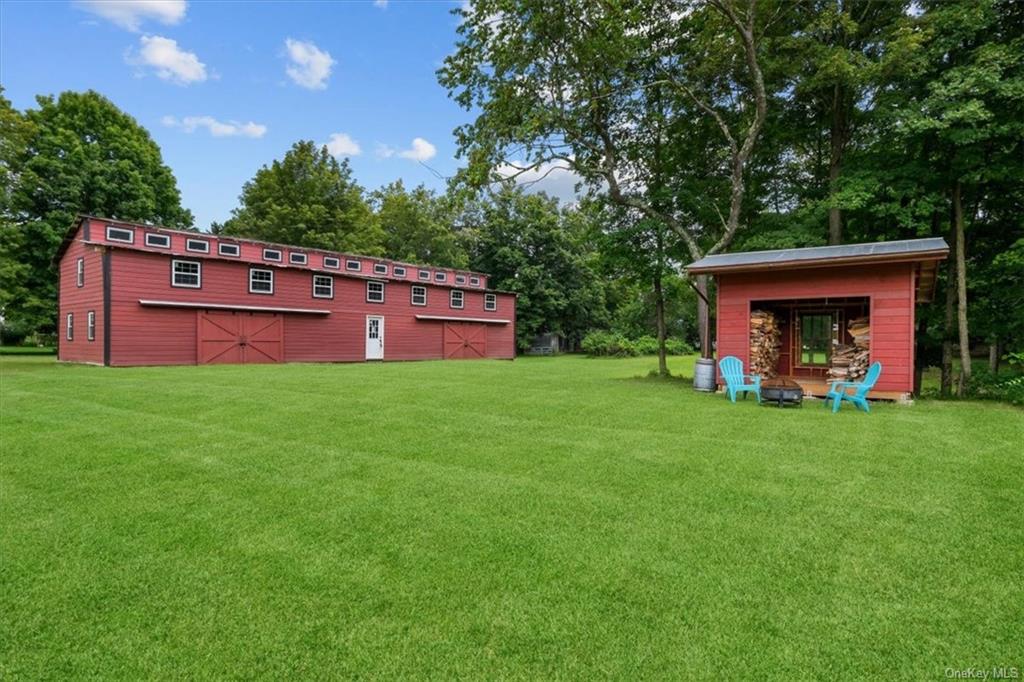 a view of a deck in front of a big yard with large trees