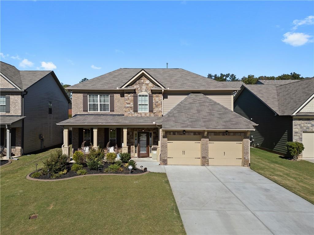 a front view of a house with a yard and garage