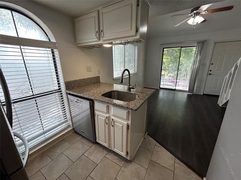 a kitchen with stainless steel appliances granite countertop a sink stove and cabinets