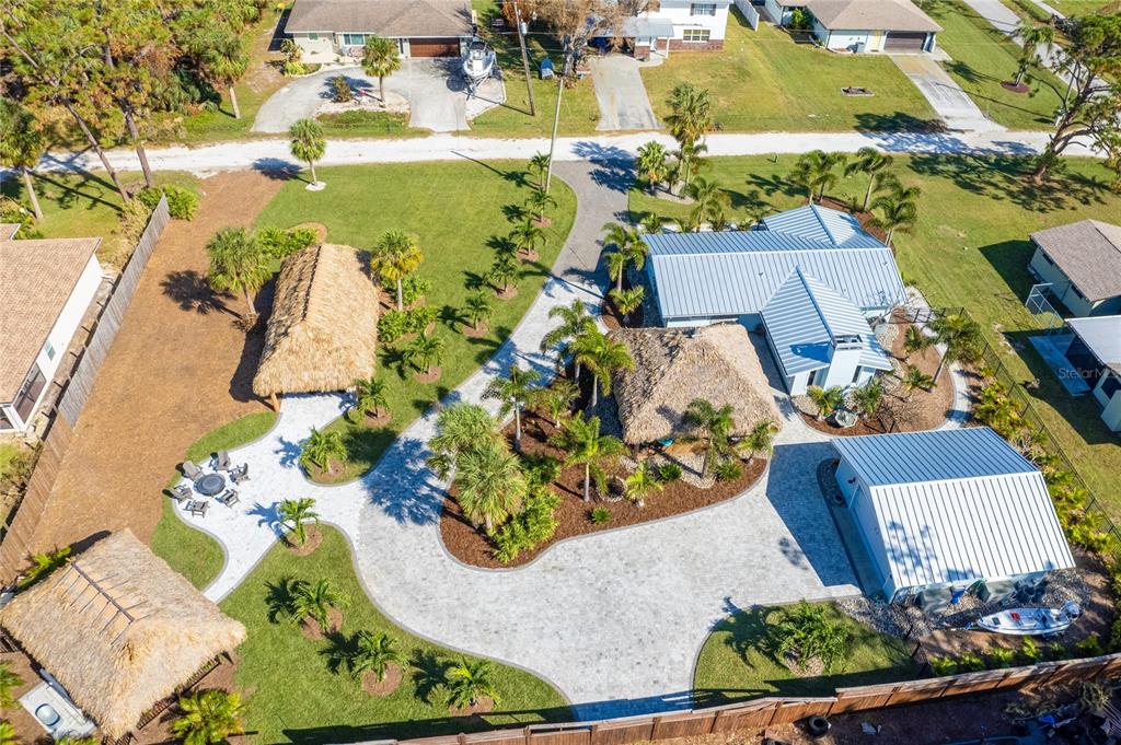 an aerial view of a house with a yard and lake view