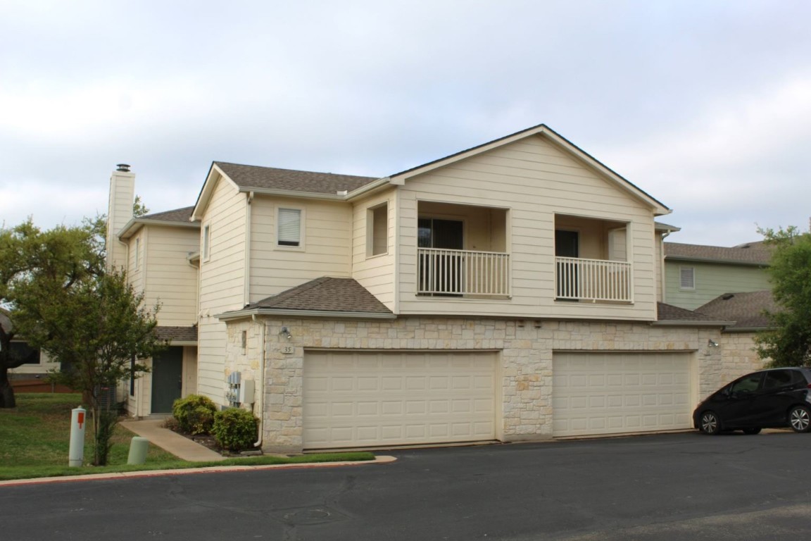 a view of a house with a parking space