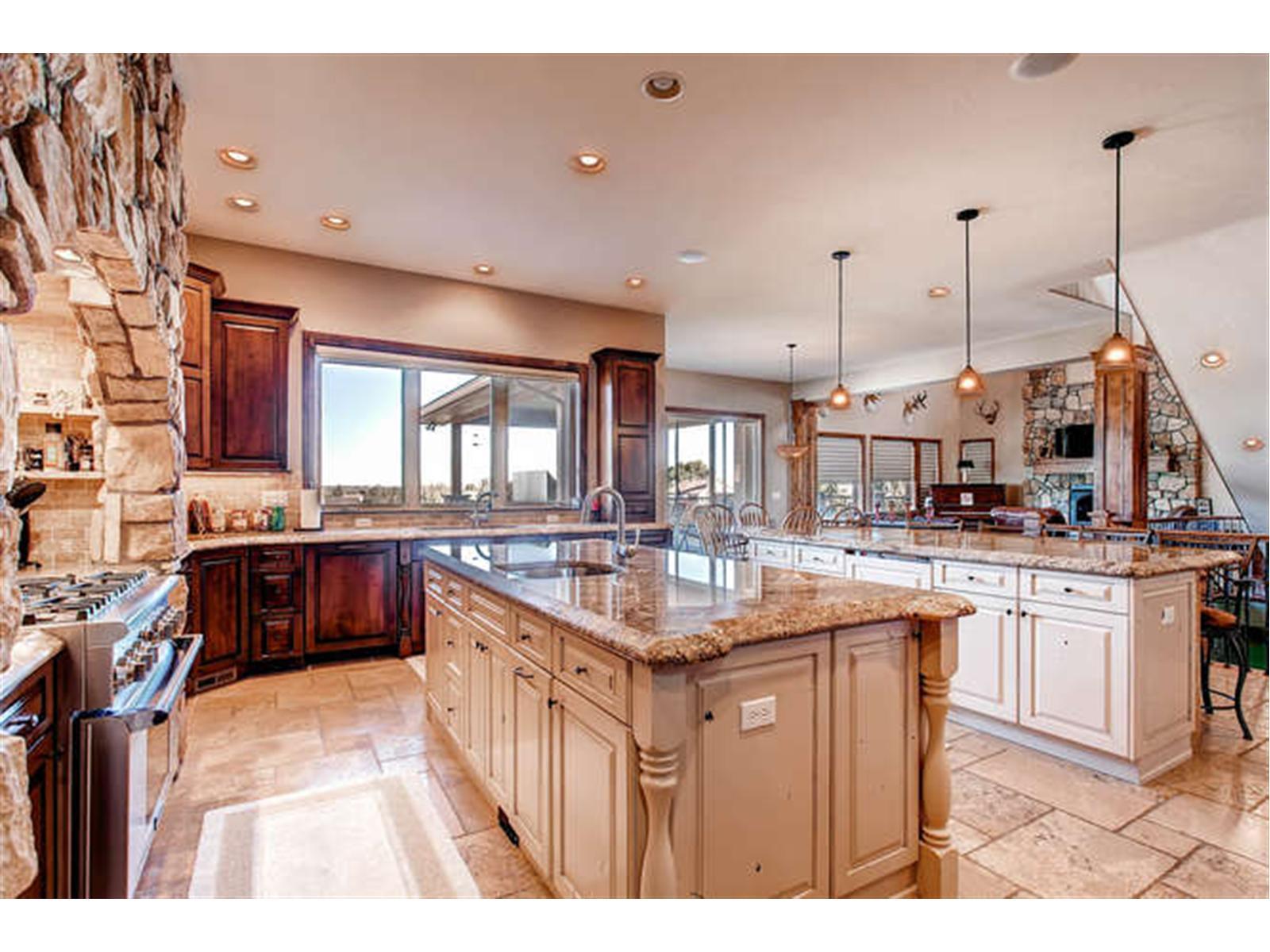 a kitchen with stainless steel appliances granite countertop a sink and cabinets