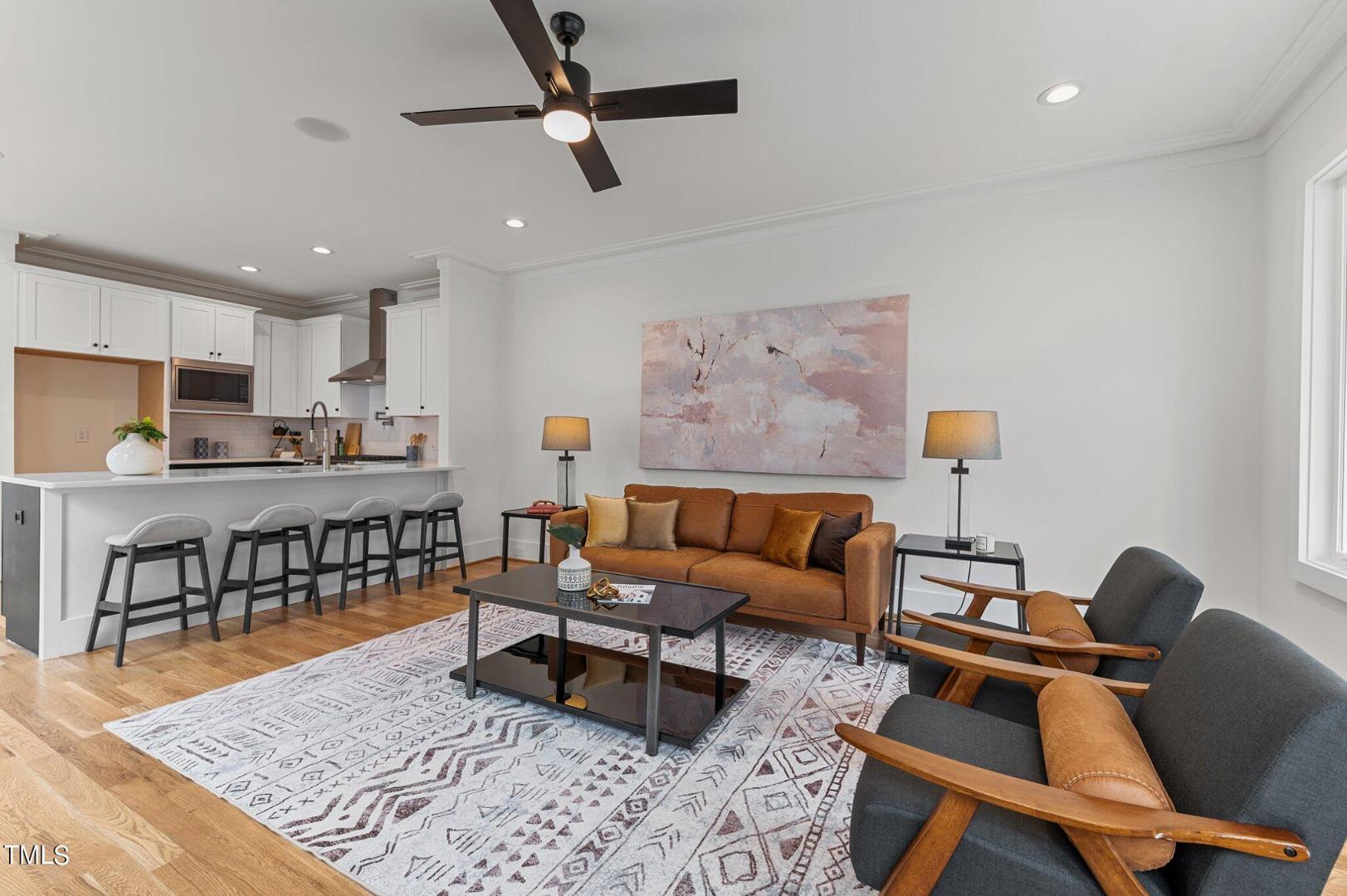 a living room with furniture and kitchen view