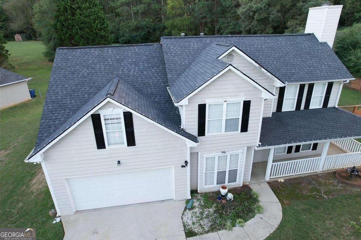 a aerial view of a house next to a yard