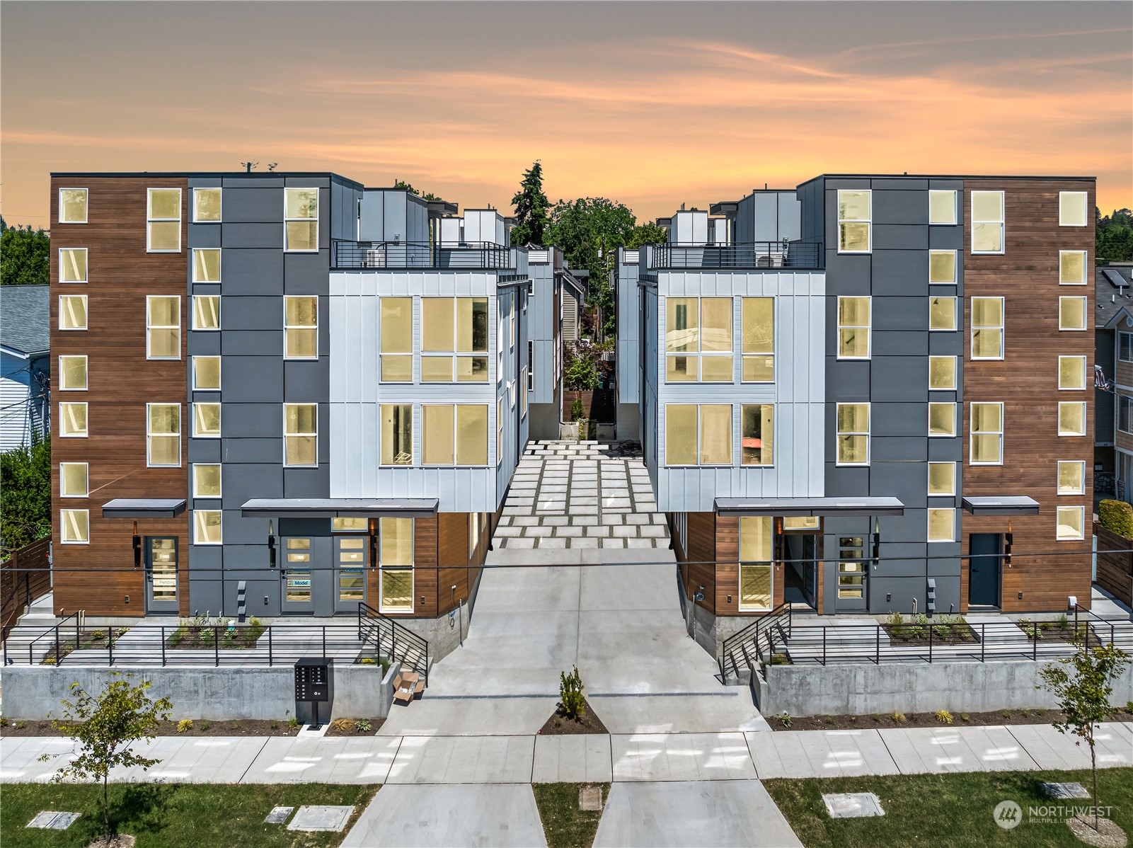 a front view of a residential apartment building with a yard