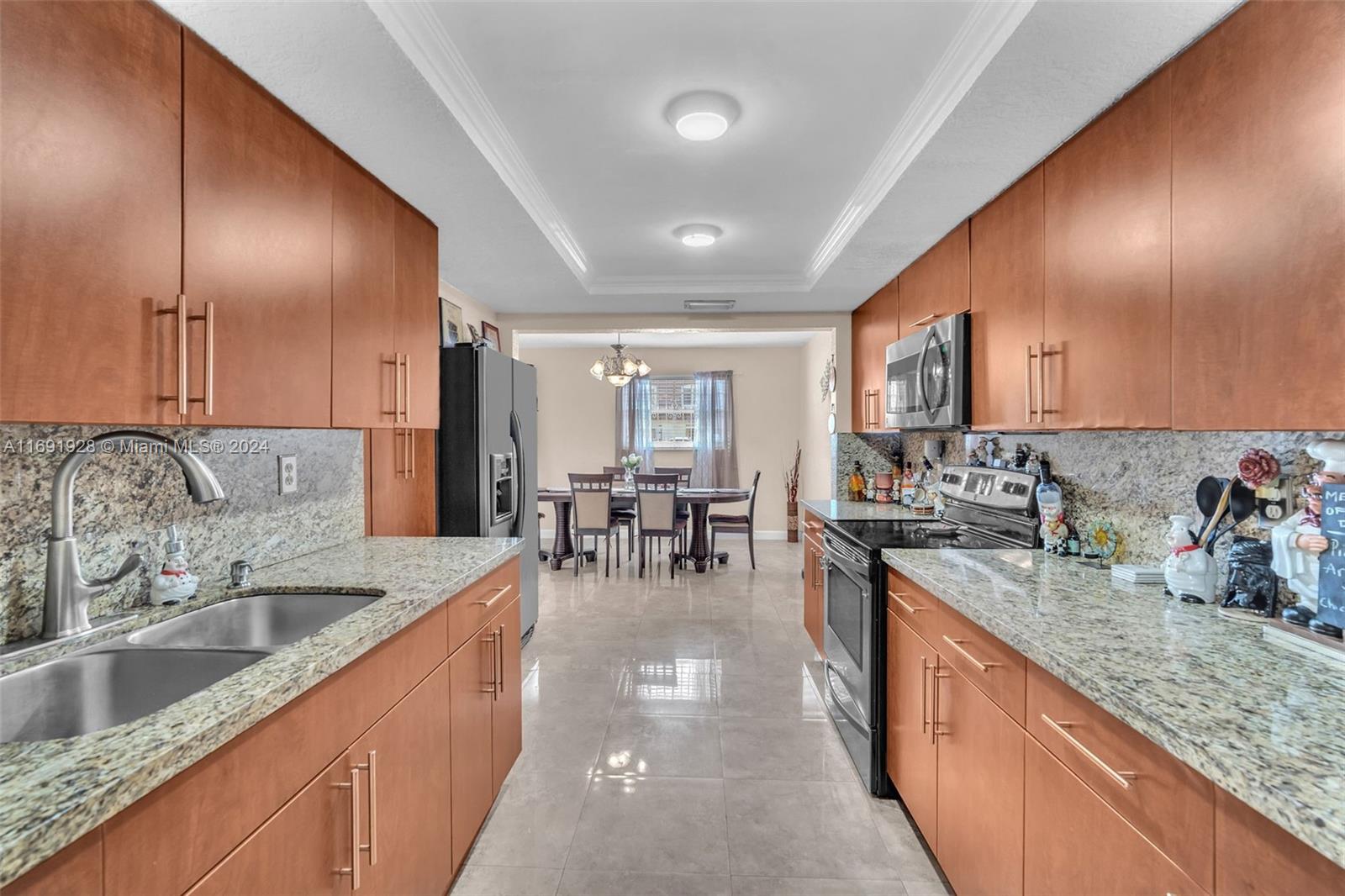 a kitchen with stainless steel appliances granite countertop sink stove and cabinets