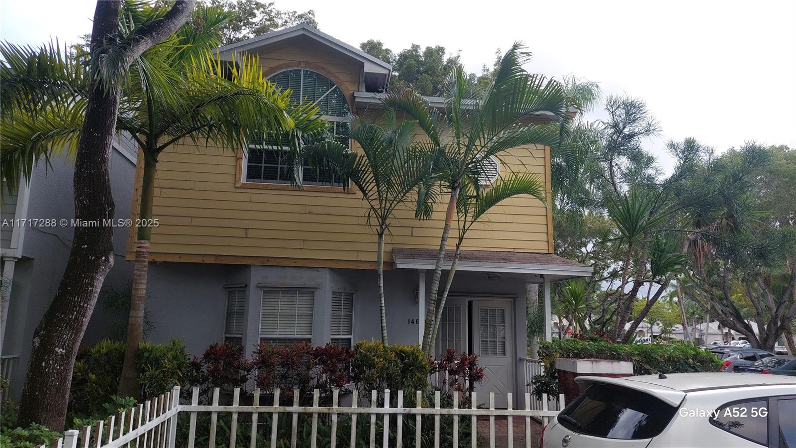 a front view of house along with deck and outdoor seating