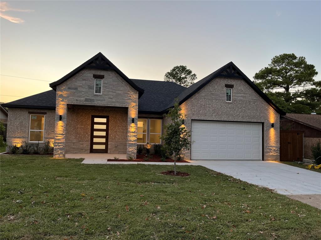 a front view of a house with a yard and garage