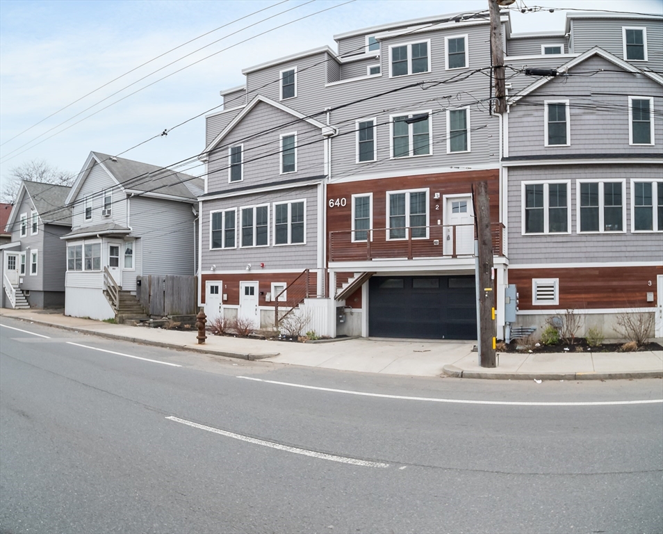 a front view of a building and car parked