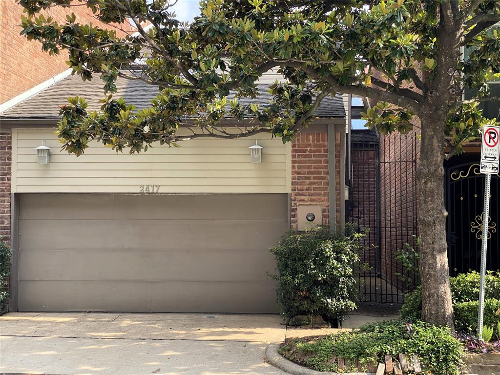 a house that has a tree in front of the house