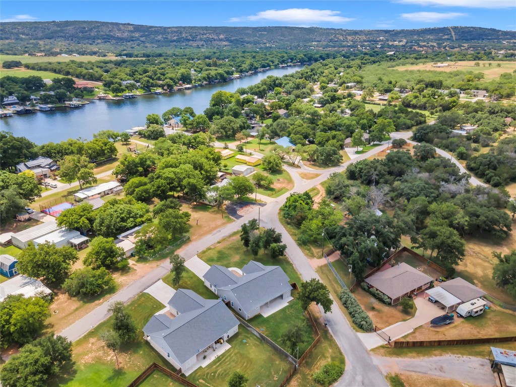 an aerial view of residential houses with outdoor space and river