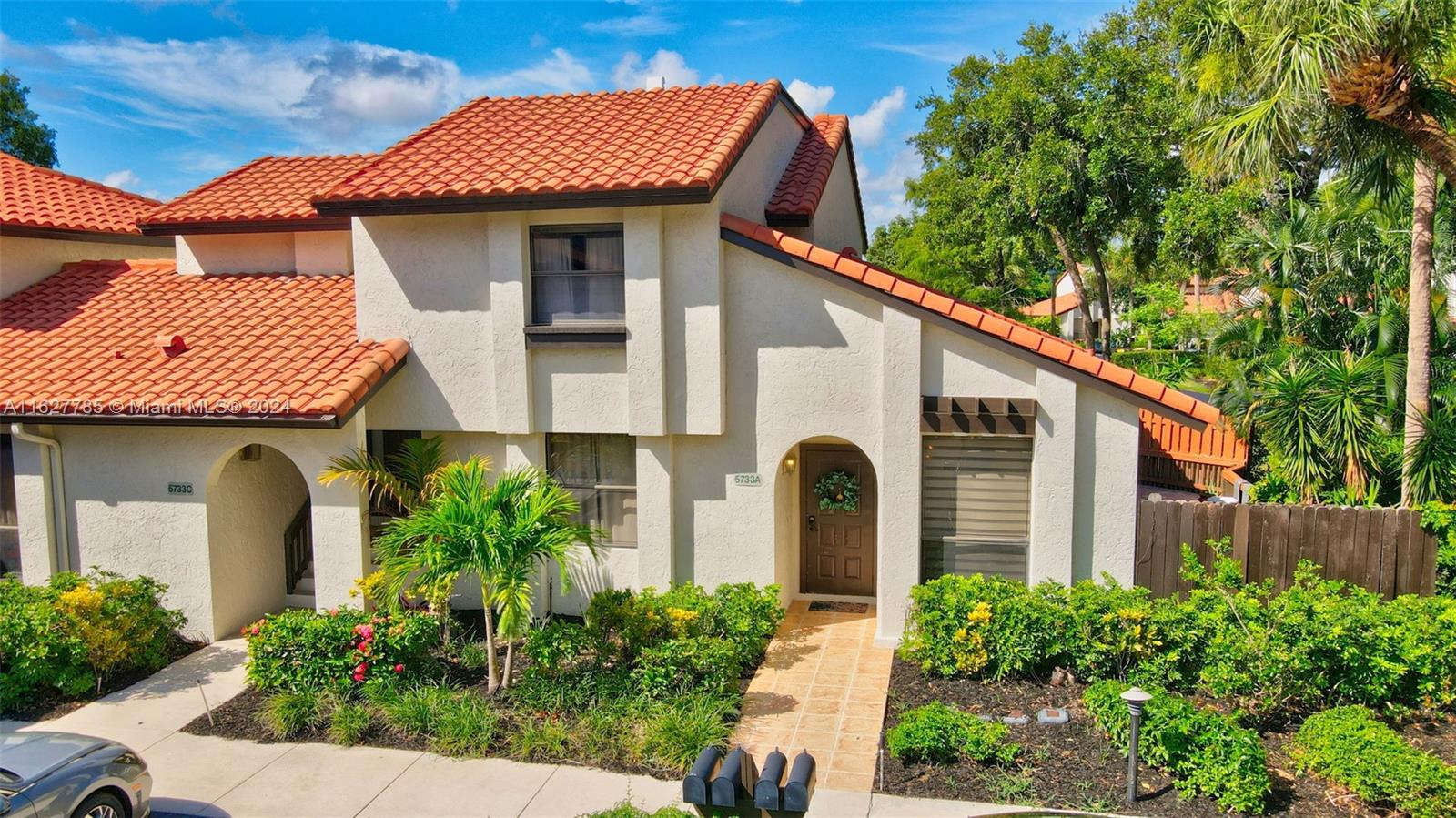 a front view of a house with garden