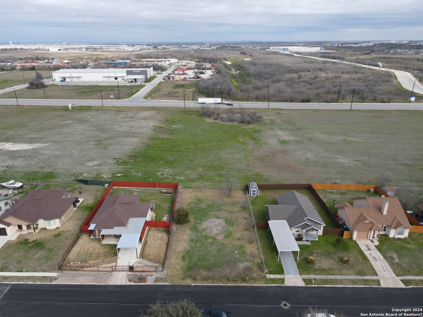 an aerial view of residential houses with outdoor space