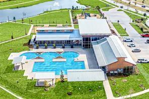 an aerial view of a house with swimming pool garden and patio