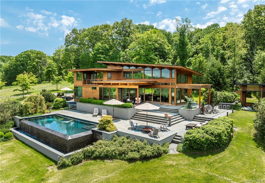 aerial view of a house with swimming pool and sitting area