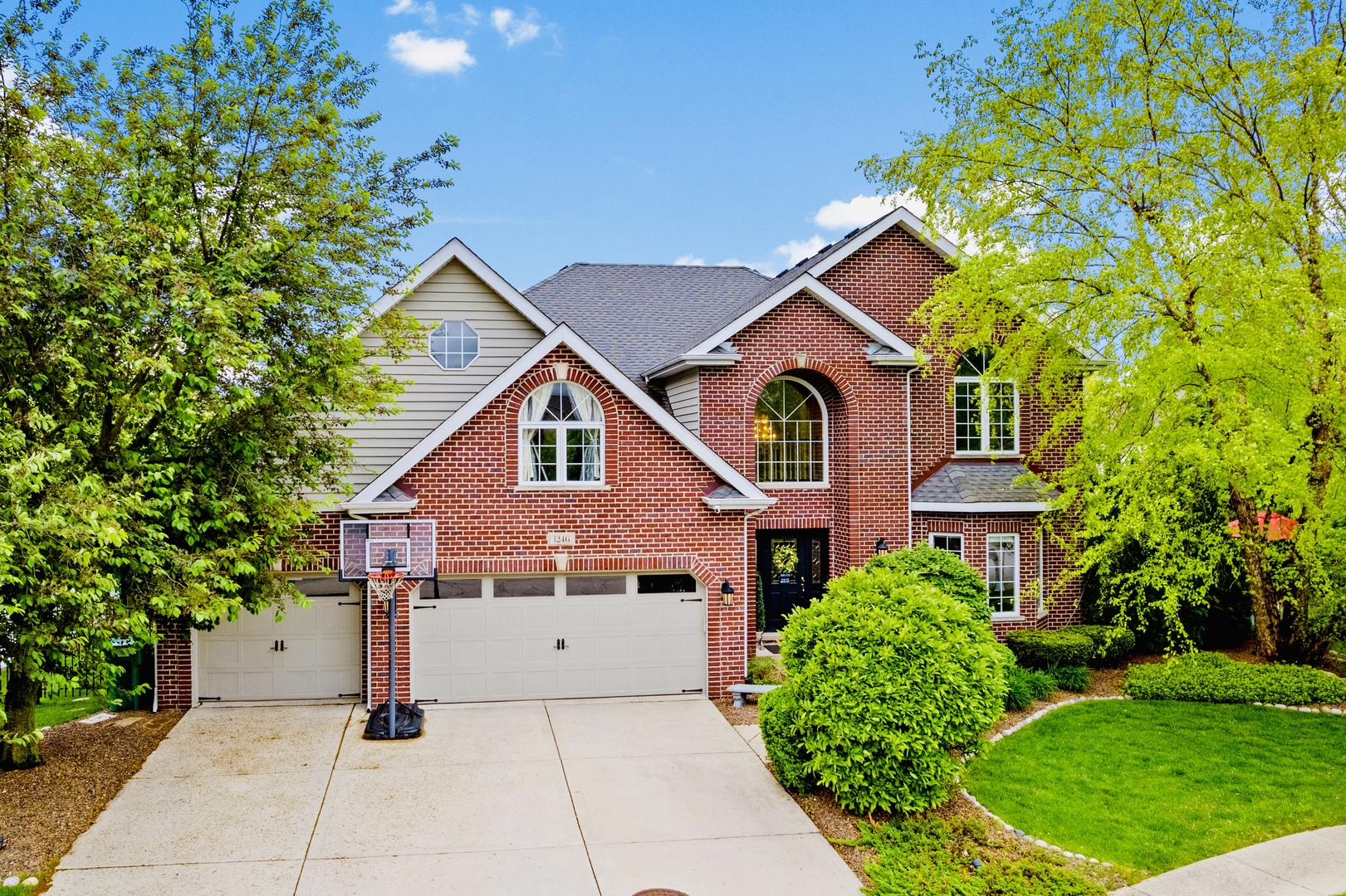 a front view of a house with a garden