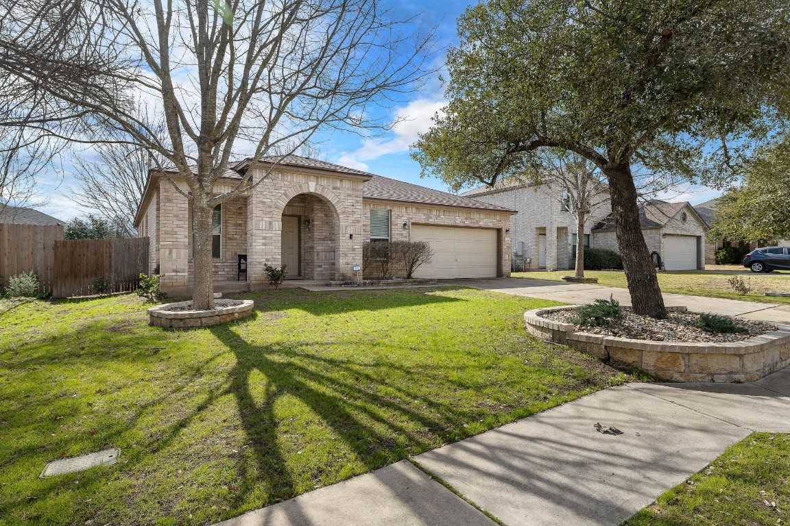 a front view of a house with yard and green space