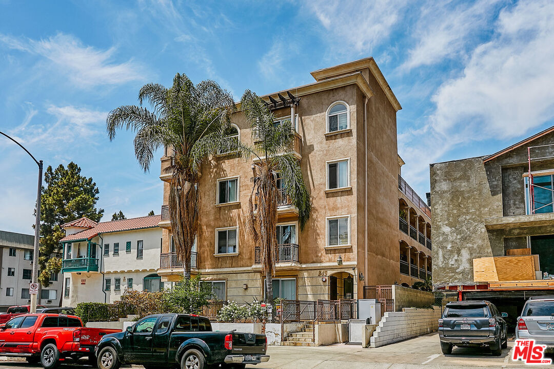 a front view of a residential apartment building with a yard