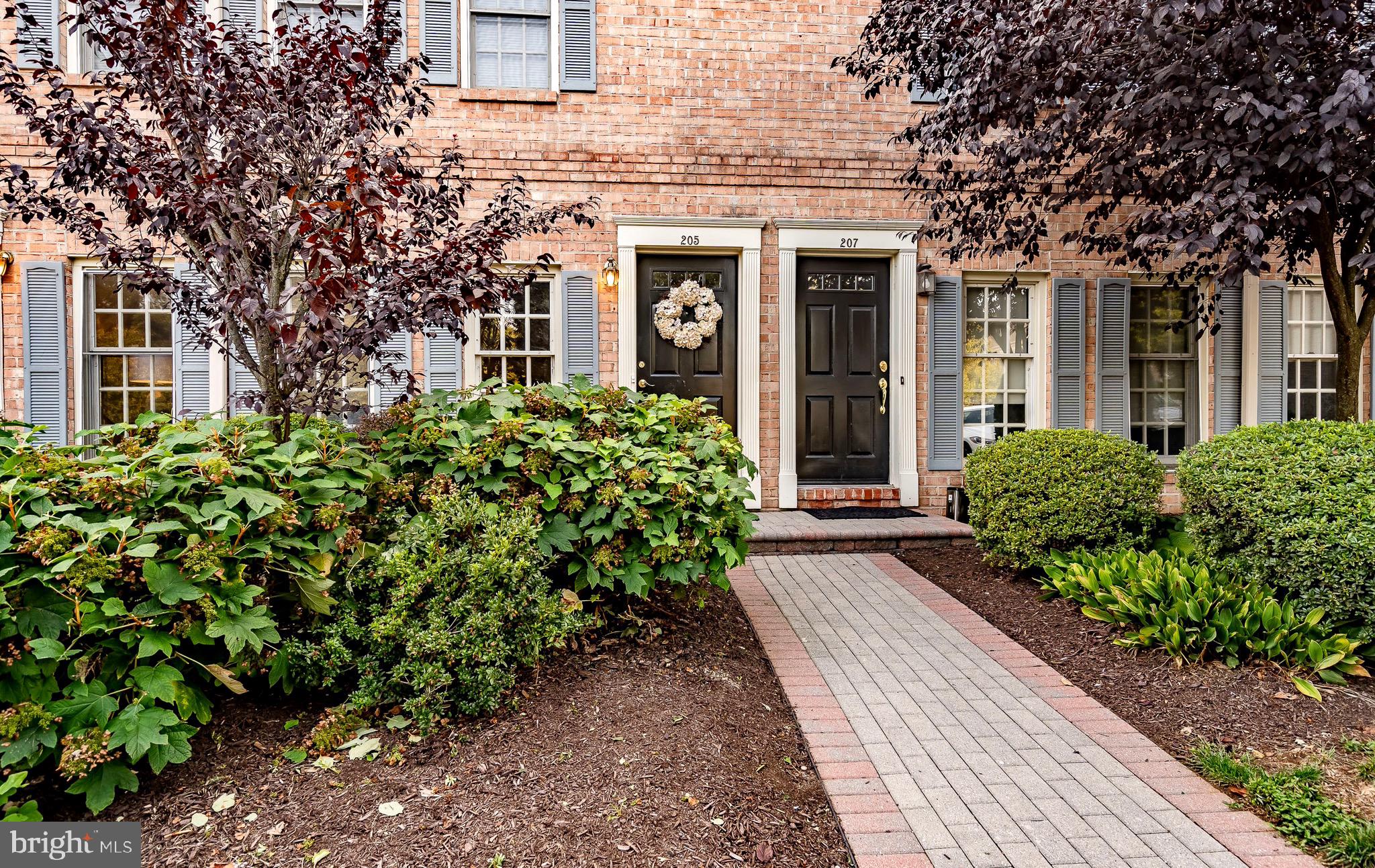 front view of a brick house with a large window