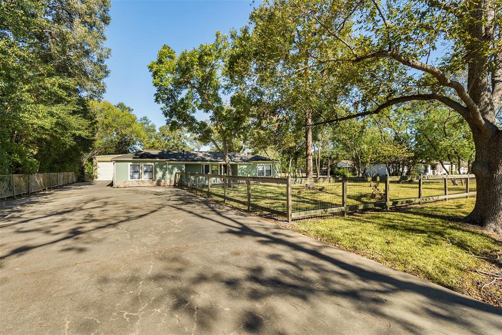 a view of a yard with wooden fence