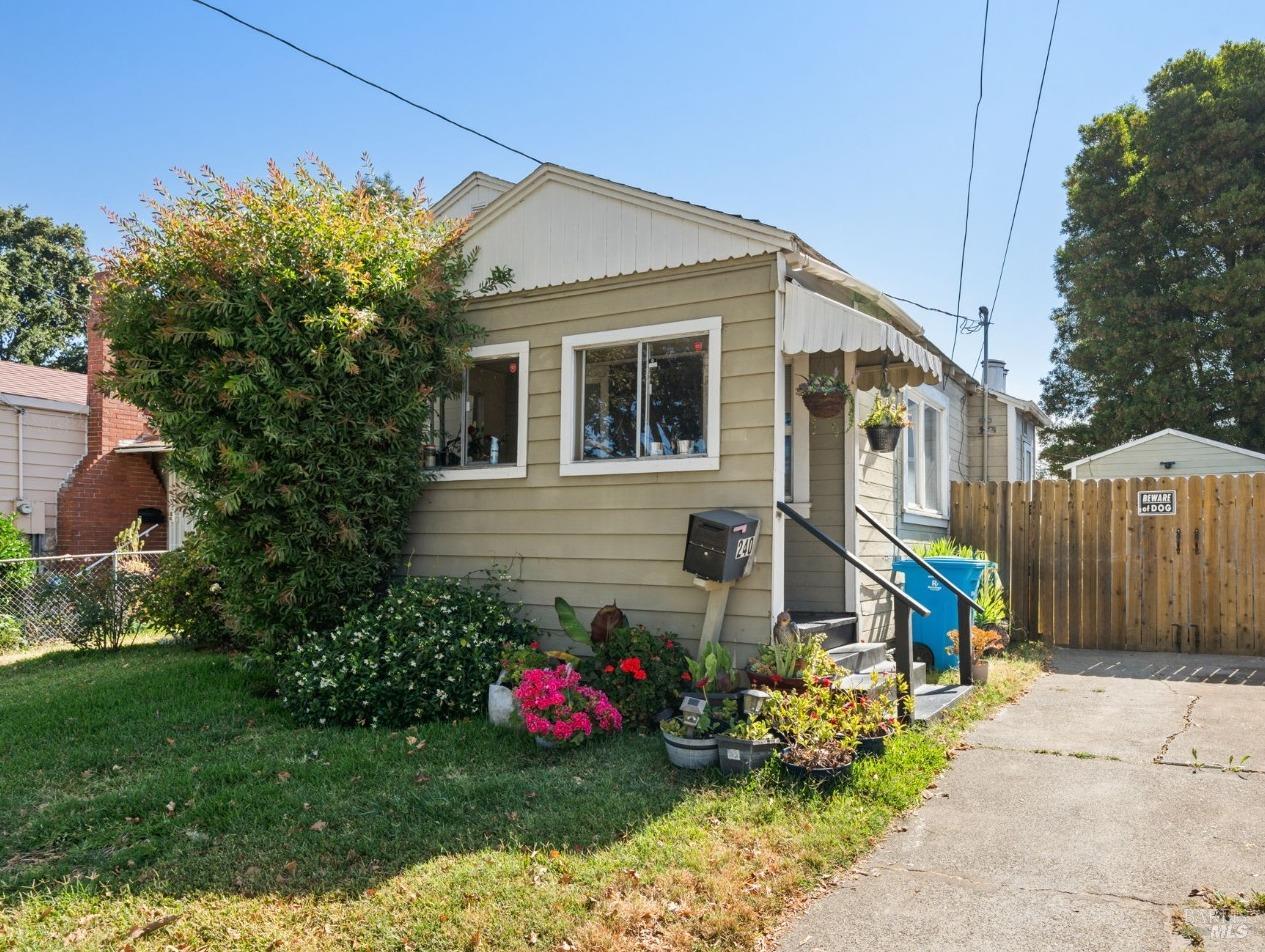 a view of a house with backyard sitting area and garden