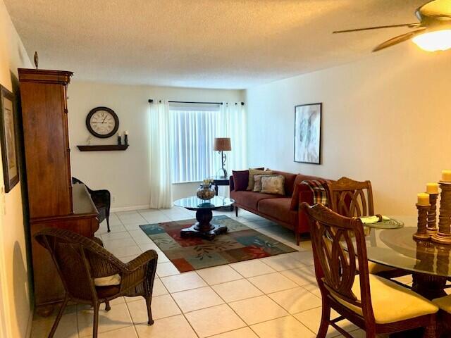 a living room with furniture a rug and a window