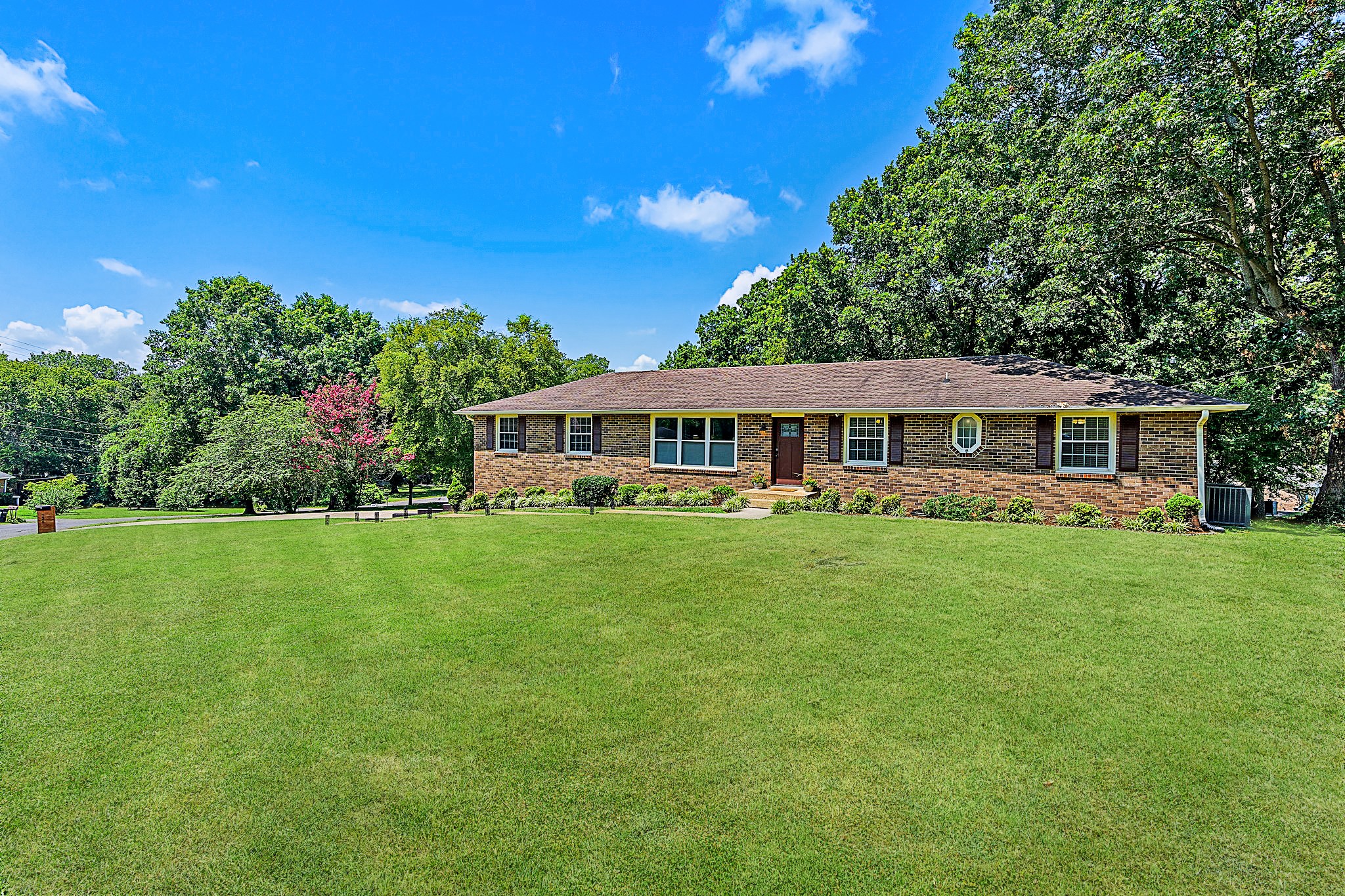 a front view of a house with a garden