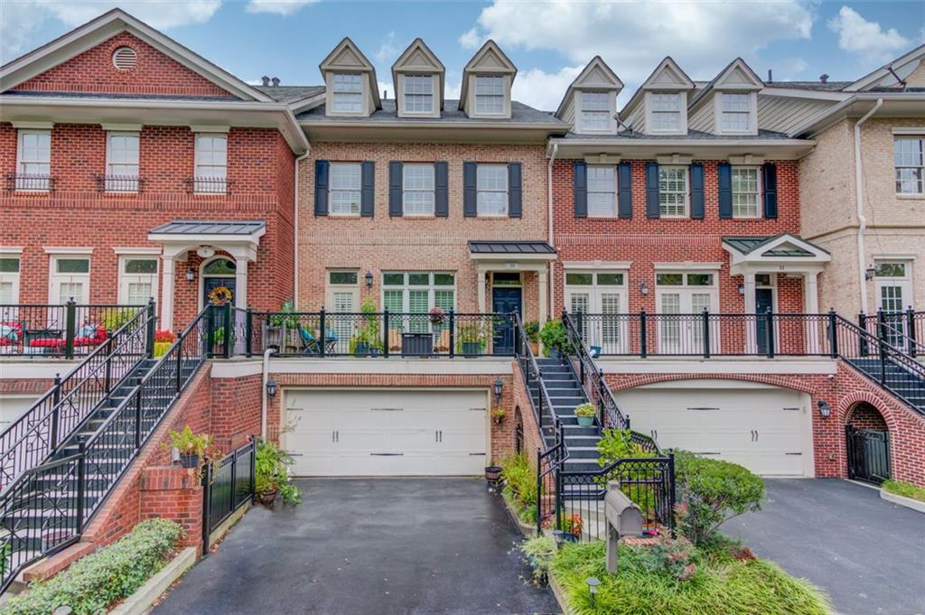 front view of a brick house with a yard