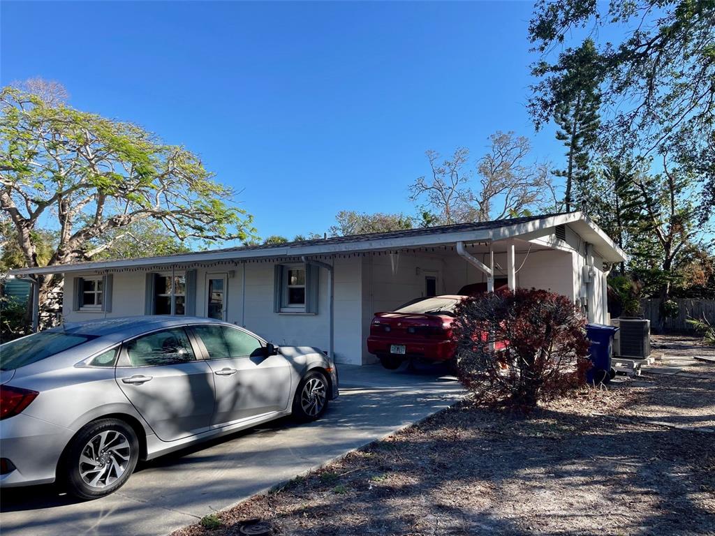 a front view of a house with cars parked