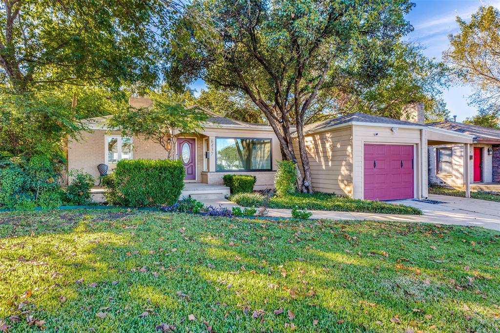 a view of a house with a yard and tree s