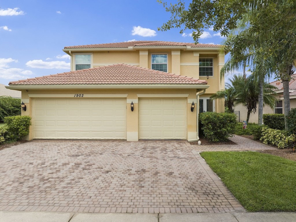 a front view of a house with a yard and garage